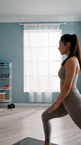woman practicing yoga and exercising in a home gym