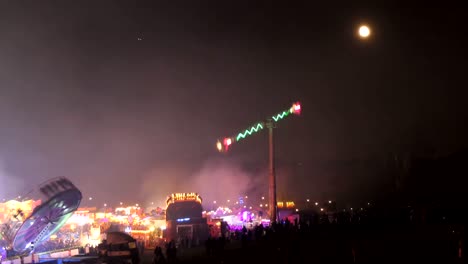 many people at funfair at night