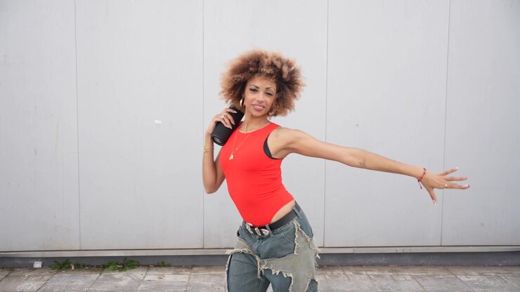 Trendy young dancer showcasing their skills in a vibrant urban setting filled with creativity