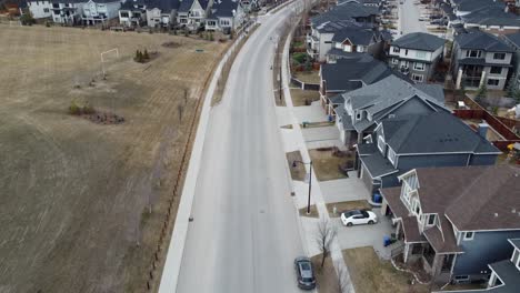 Aerial-view-of-a-modern-suburban-community-in-Calgary,-Canada,-in-spring-after-the-snow-melt