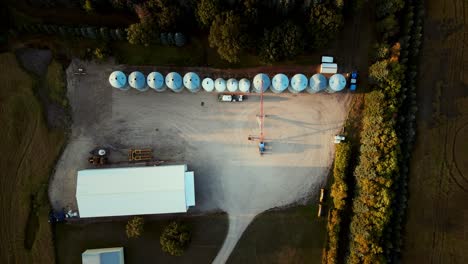 a top down overhead aerial drone shot of a small agriculture farm property in a rural canadian town