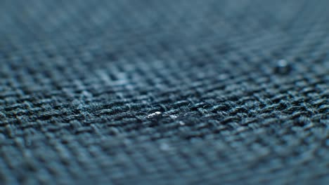 view a close-up of water droplets forming on a fabric surface. this demonstration highlights the effectiveness of waterproof technology and showcases material resistance to liquid penetration.