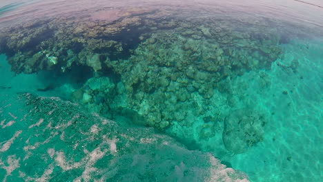 Still-Water,-Circling-Shallow-Coral-Reef-White-Boat-Wake-SLOW-HANDHELD