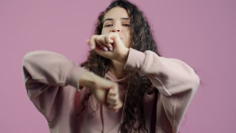 woman dancing in a pink hoodie