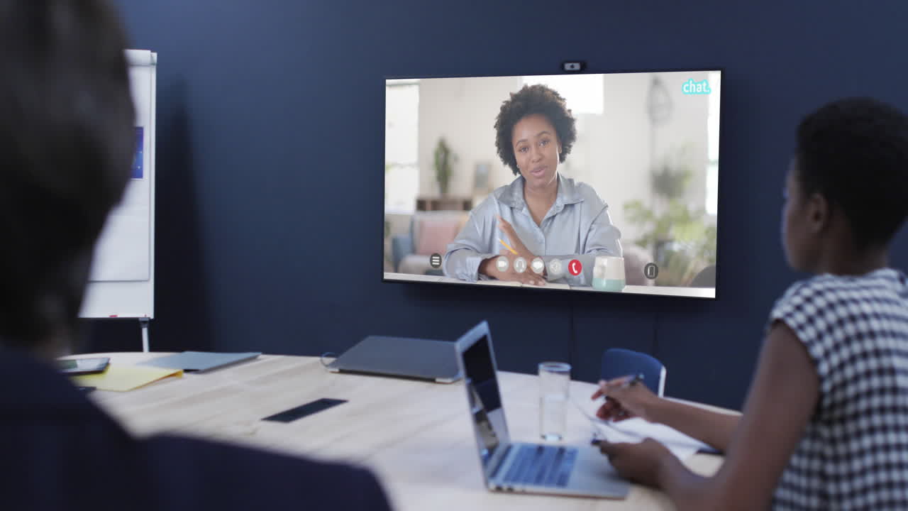 Diverse business people on video call with african american female colleague on screen