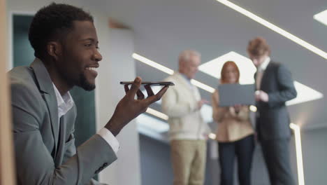 young african businessman recording voice message