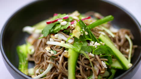 Noodle-salad-bowl-asian-food-spinning-in-close-up