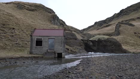 small hut by a stream