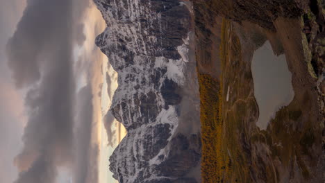 vertical 4k time lapse, valley of ten peaks, banff national park canada, clouds moving above snow capped summits on cold autumn day