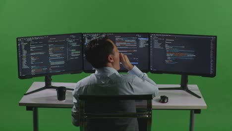 programmer working on multiple screens