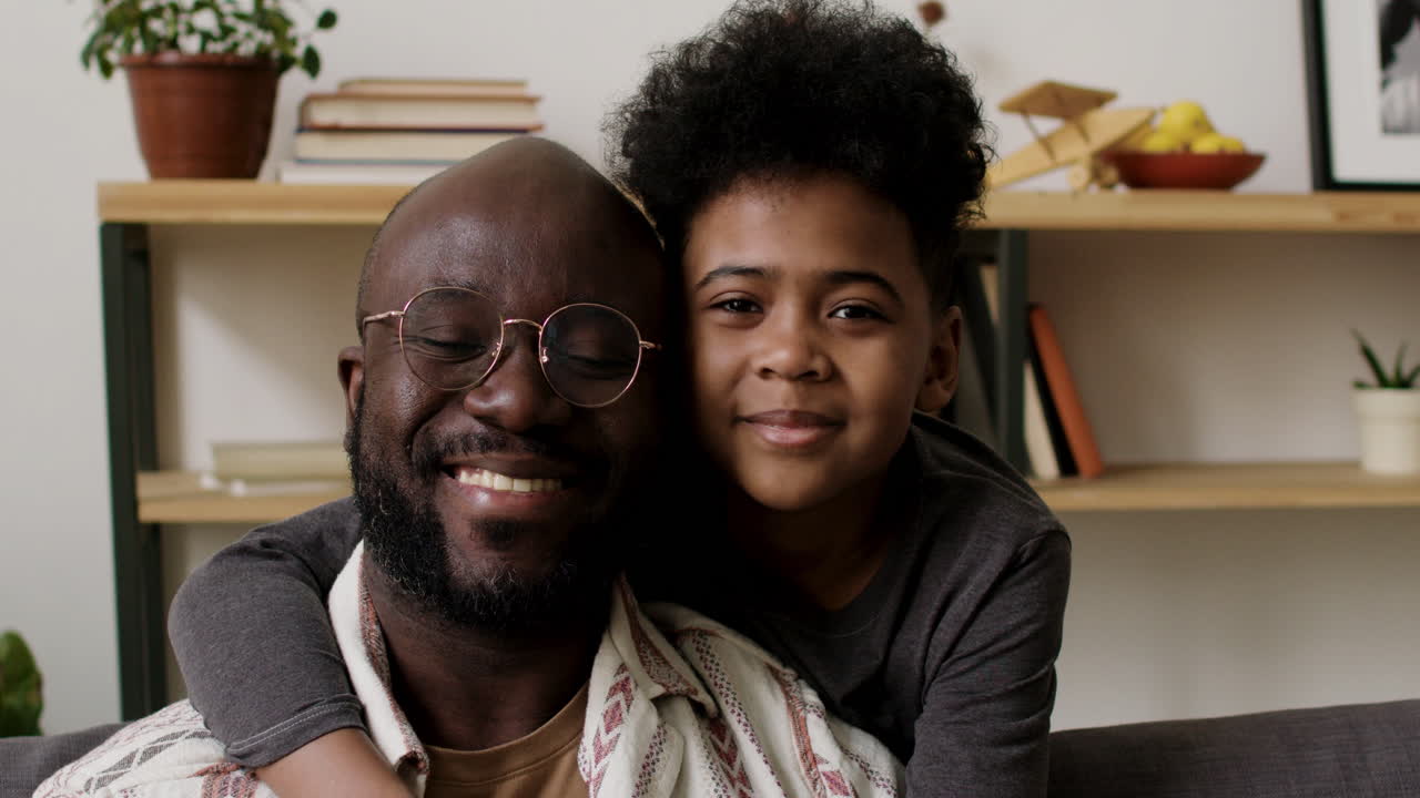 Father and son hugging in the living room