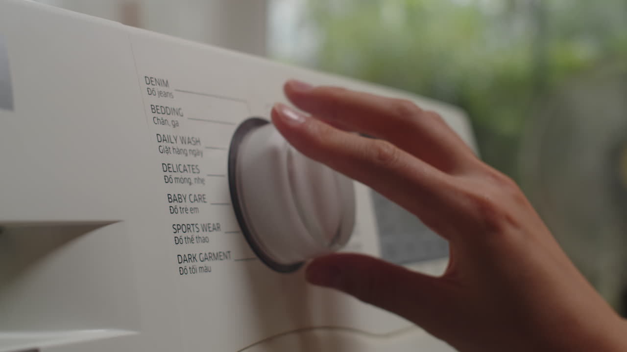 Person Setting Cycle of Washing Machine