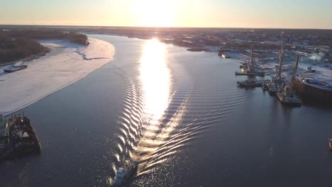 river sunset with ships and ice