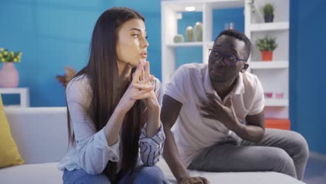 interracial married couple fighting at home in the evening. scandal and crisis in the family. domestic violence, harassment.