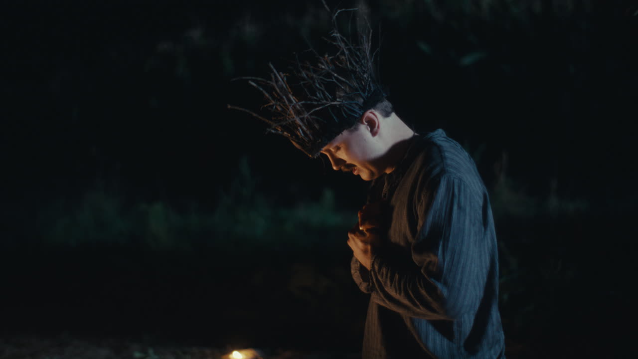 Man in Branch Crown During a Mysterious Night Ritual