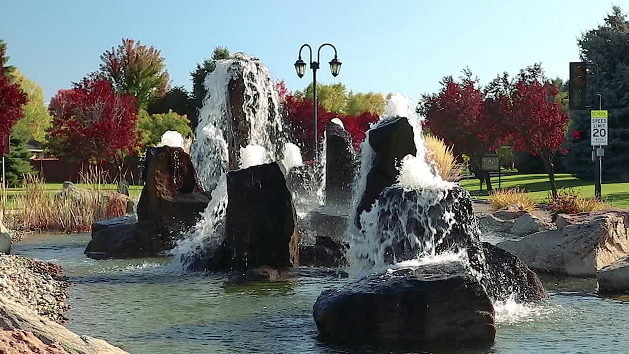 Tall Water Fountains And Water Features Surrounded By Foliage Slow Motion 20 Second Video