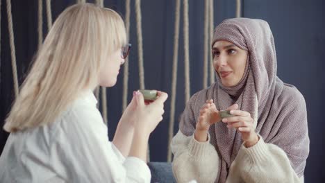 two women enjoying conversation in a cafe