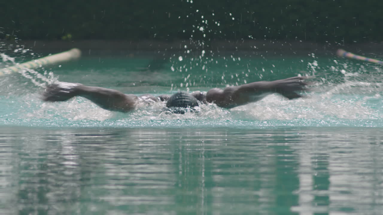 African American Swimmer Having Workout in Outdoor Pool