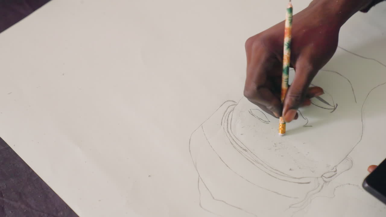 Black artist sketching portrait on paper, closeup of dark hands guiding pencil over dotted outline, careful graphite shading, calm studio atmosphere, portrait commission study, classroom demo, gallery