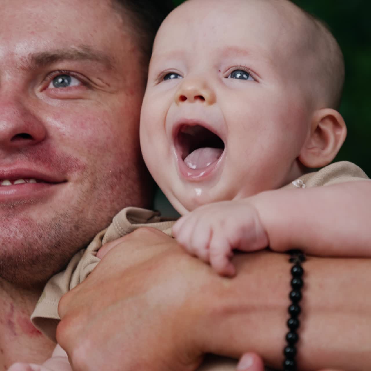 Attractive new family concept. Playful young father with newborn small baby