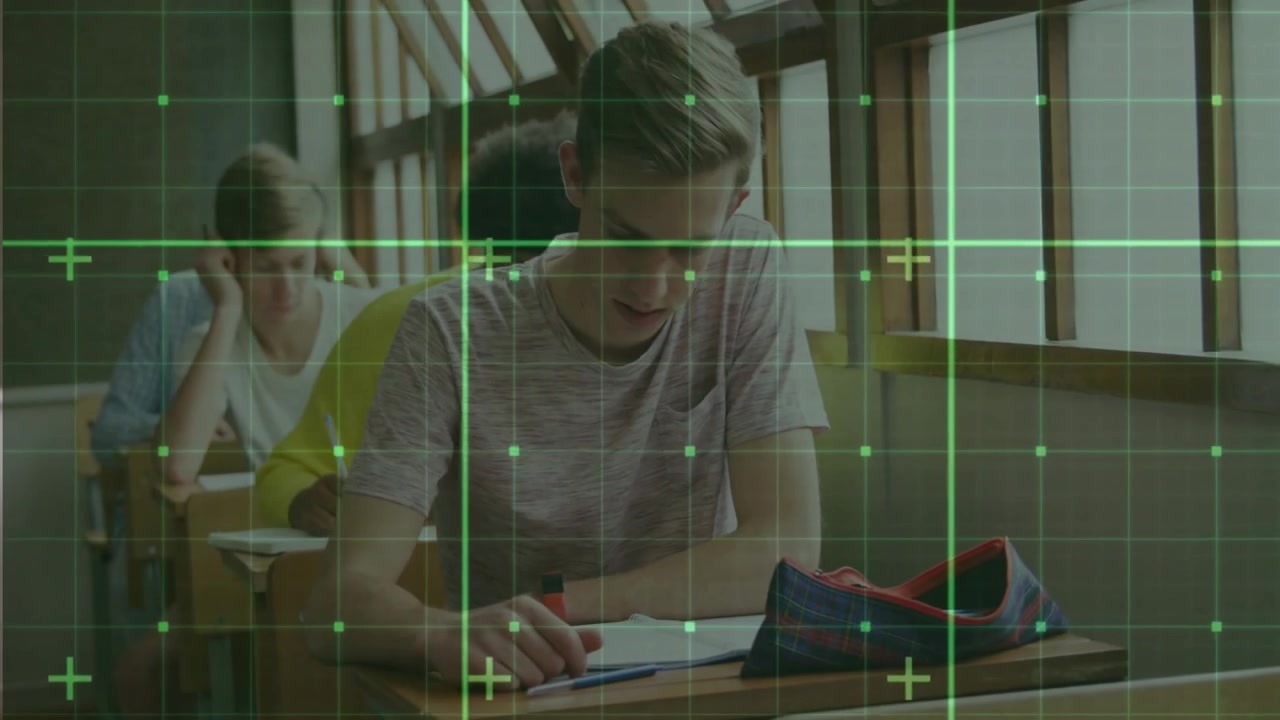 Teenage male student placing red pen and starting exam writing after green grid overlay settling