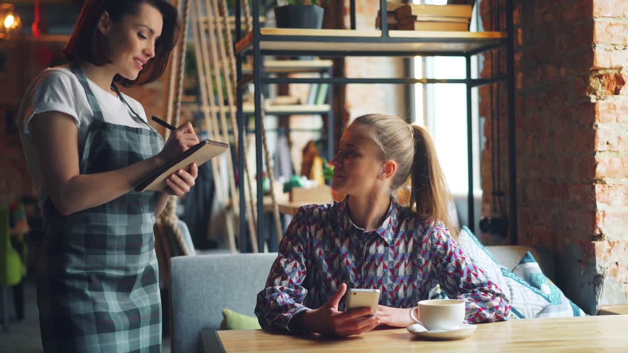 Waiter Taking Order in a Cafe