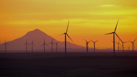 dramatic view of mount hood and windmills farm during golden hour in eastern oregon, usa. slow motion