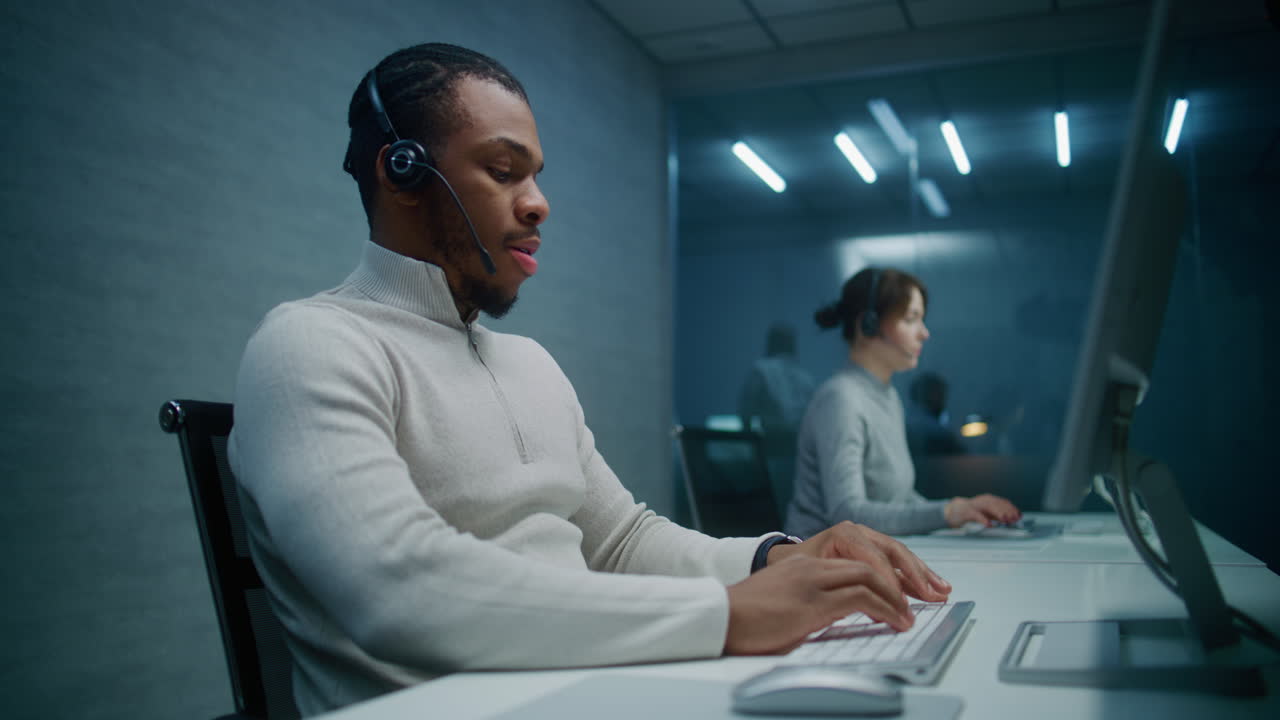 Call center agents working at computer