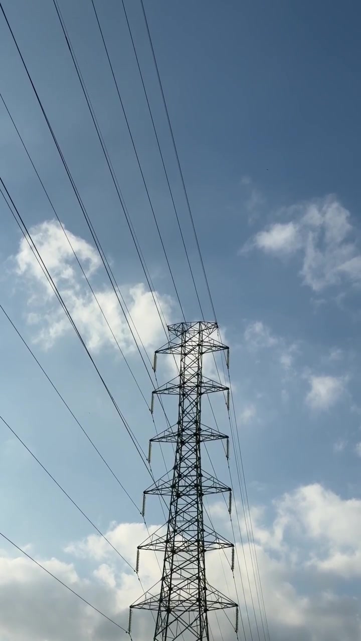 High Voltage Electricity Transmission Tower Against Blue Sky