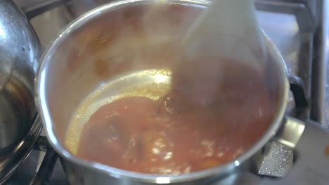 Close-up-shot-of-steam-rising-from-cooking-meatballs-in-sauce