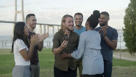 Smiling-young-people-celebrating-in-park