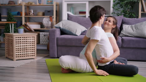 couple practicing partner yoga at home