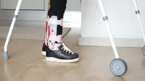 child with leg braces and walker