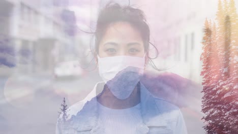 animation of woman wearing face mask over winter scenery in the background