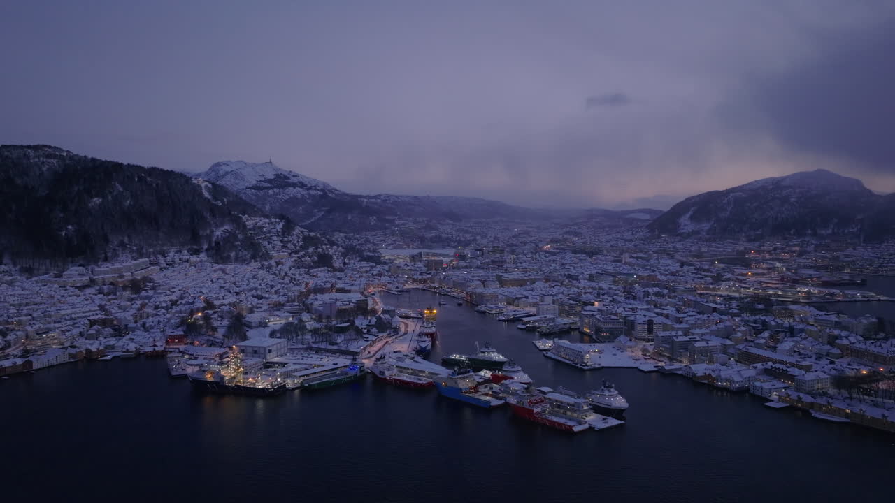 Aerial shot of downtown Bergen at dusk, beautifully covered in snow
