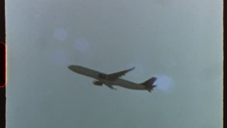 filmed on super 8 film - airplane flying in the sky with light leaks and film grain, giving a retro and vintage feel, reminiscent of super 8 film