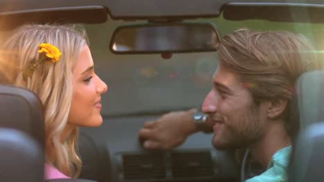 animation of light over happy caucasian couple kissing in car