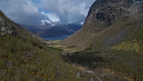 Flying-through-valley-towards-Bondhusvastnet-Lake,-Norway