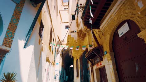 small alley between houses at the casbah of algiers with algerian flags