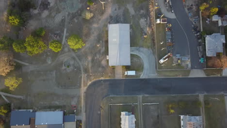 aerial: top down drone shot of houses to a slow tilt up to reveal more of the town, in stanthorpe queensland