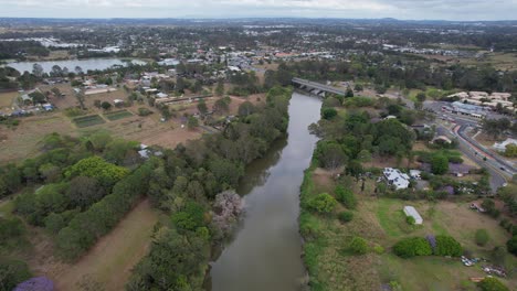 Larry-Storey-Bridge-Spanning-Logan-River-With-View-Of-Tygum-Lagoon-And-Park-In-Waterford,-QLD,-Australia