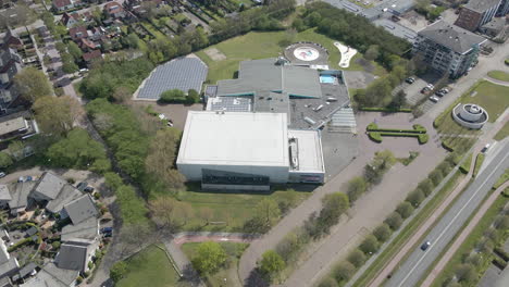 Antena-De-Un-Centro-Deportivo-Cubierto-Con-Un-Campo-De-Paneles-Solares-En-Una-Ciudad-Suburbana