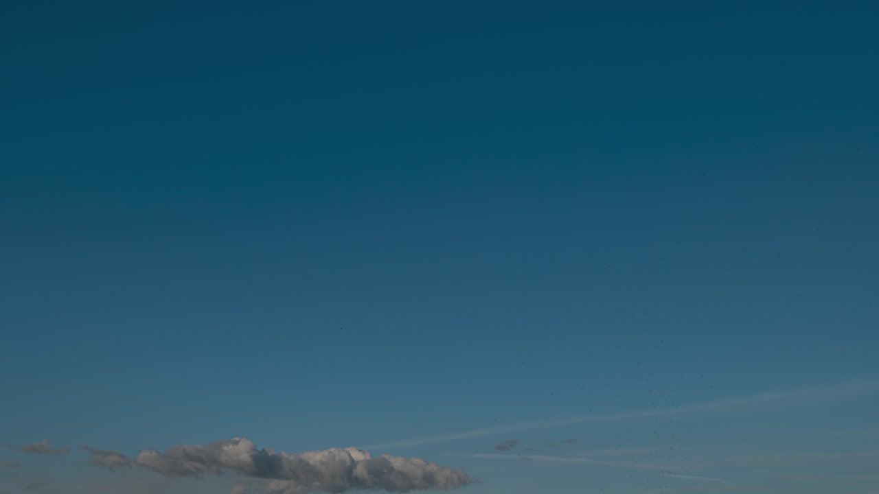Timelapse of scenic clouds moving across a bright blue sky