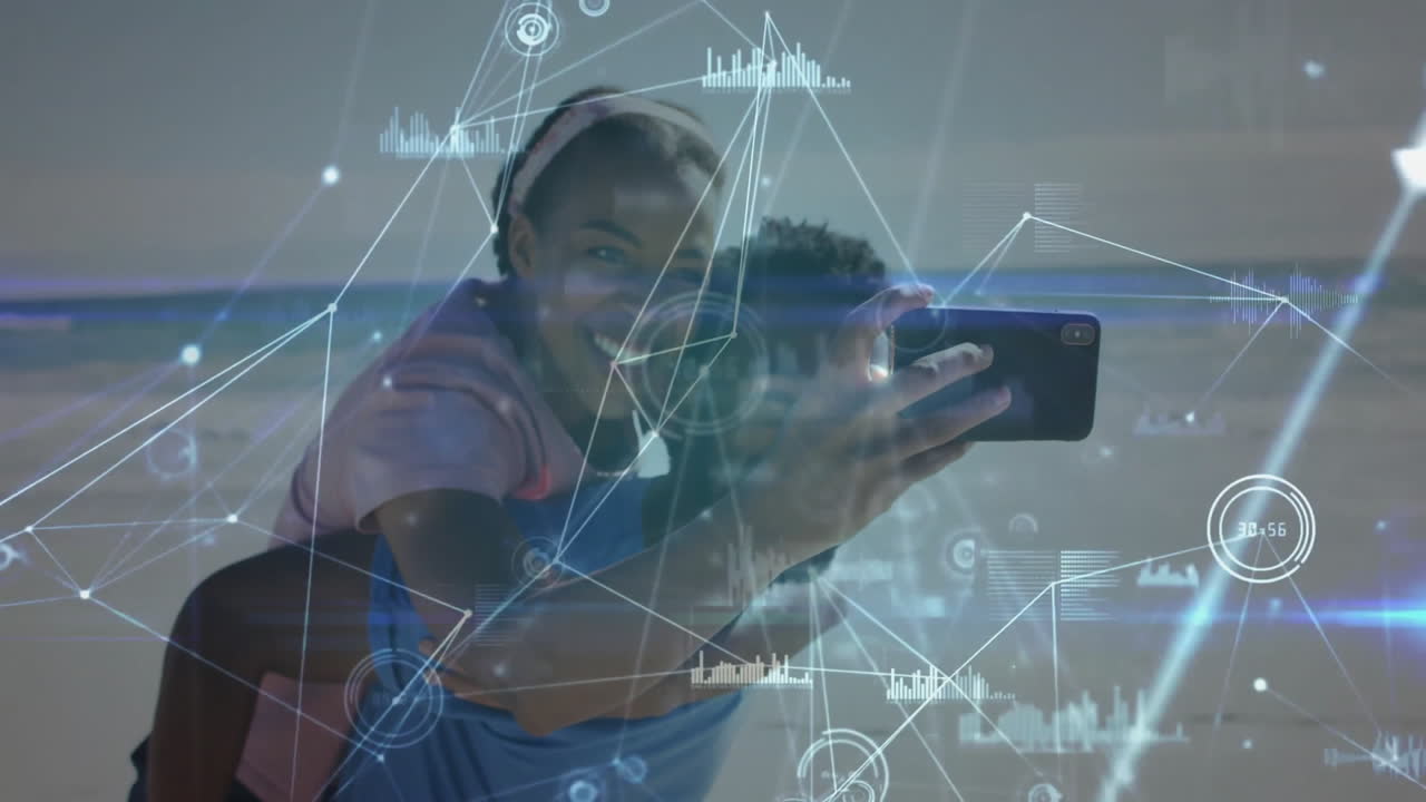 Smiling couple taking selfie on beach with digital network overlay animation