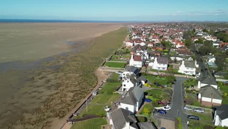 Hoylake-Beachfront-conservation-area---aerial-drone-flyover-towards-meols,-highlighting-Spartina-grass,-Wirral-UK