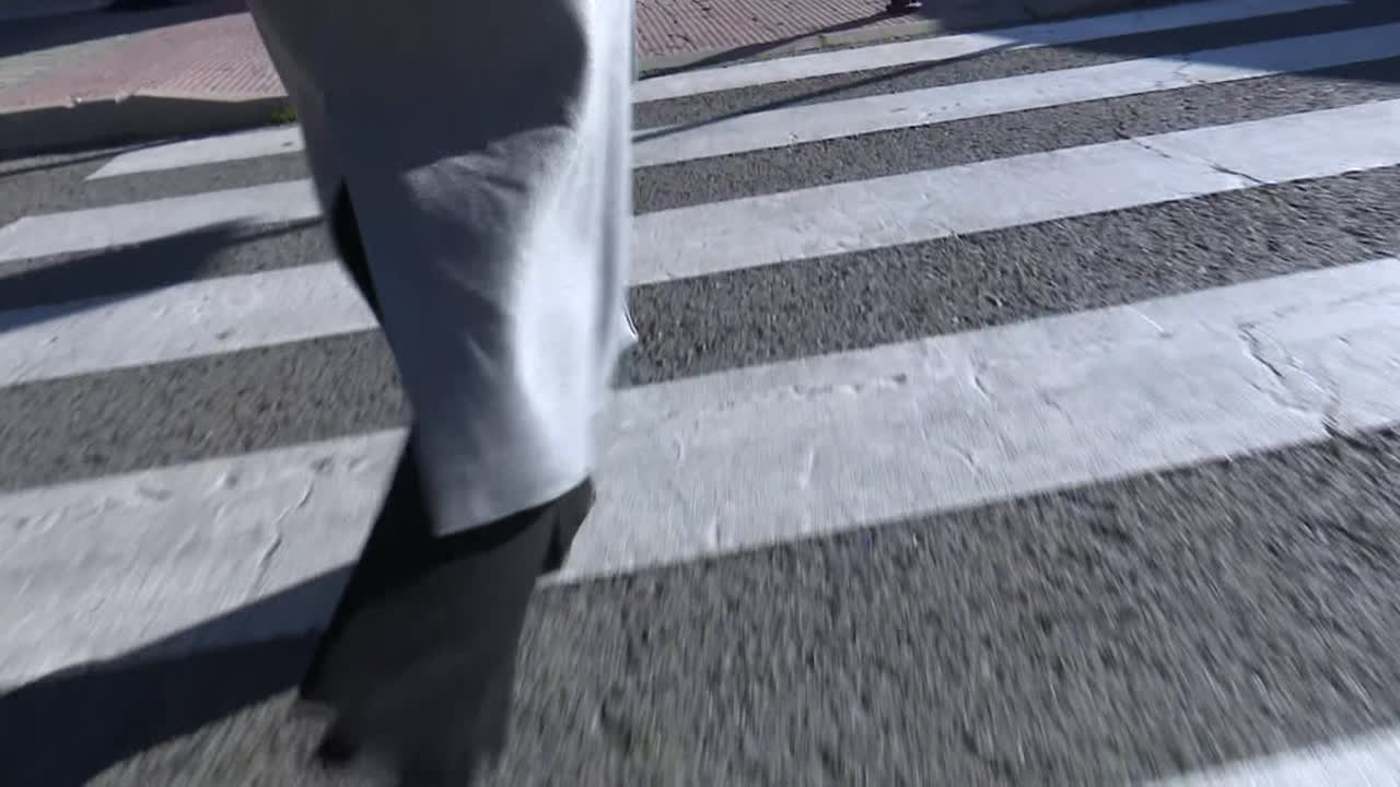 Person Walking Across a Crosswalk