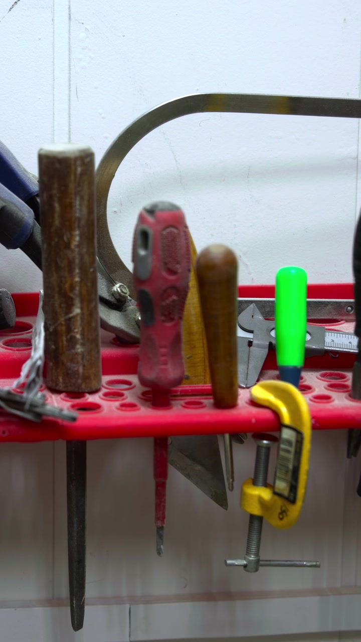 Workbench Tool Shelf With Assorted Hand Tools Lined On Red Organizer, Pliers, Screwdrivers, Hammer, Measuring