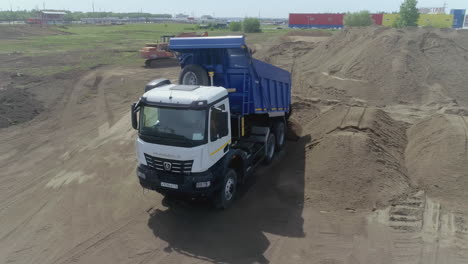 kamaz dump truck loading sand at construction site