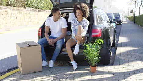 young couple relaxing while moving house