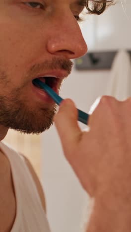 man brushing his teeth